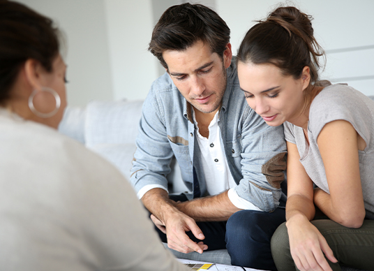 Couple speaking to advisor in living room
