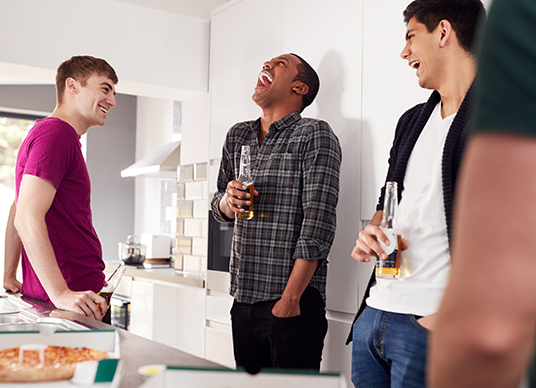 Friends meeting in kitchen at party