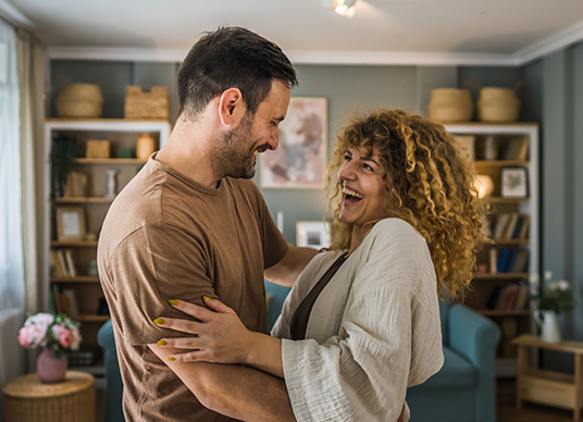 Happy couple talking in living area