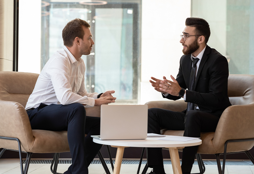 Estate agents in meeting area discussing agendas